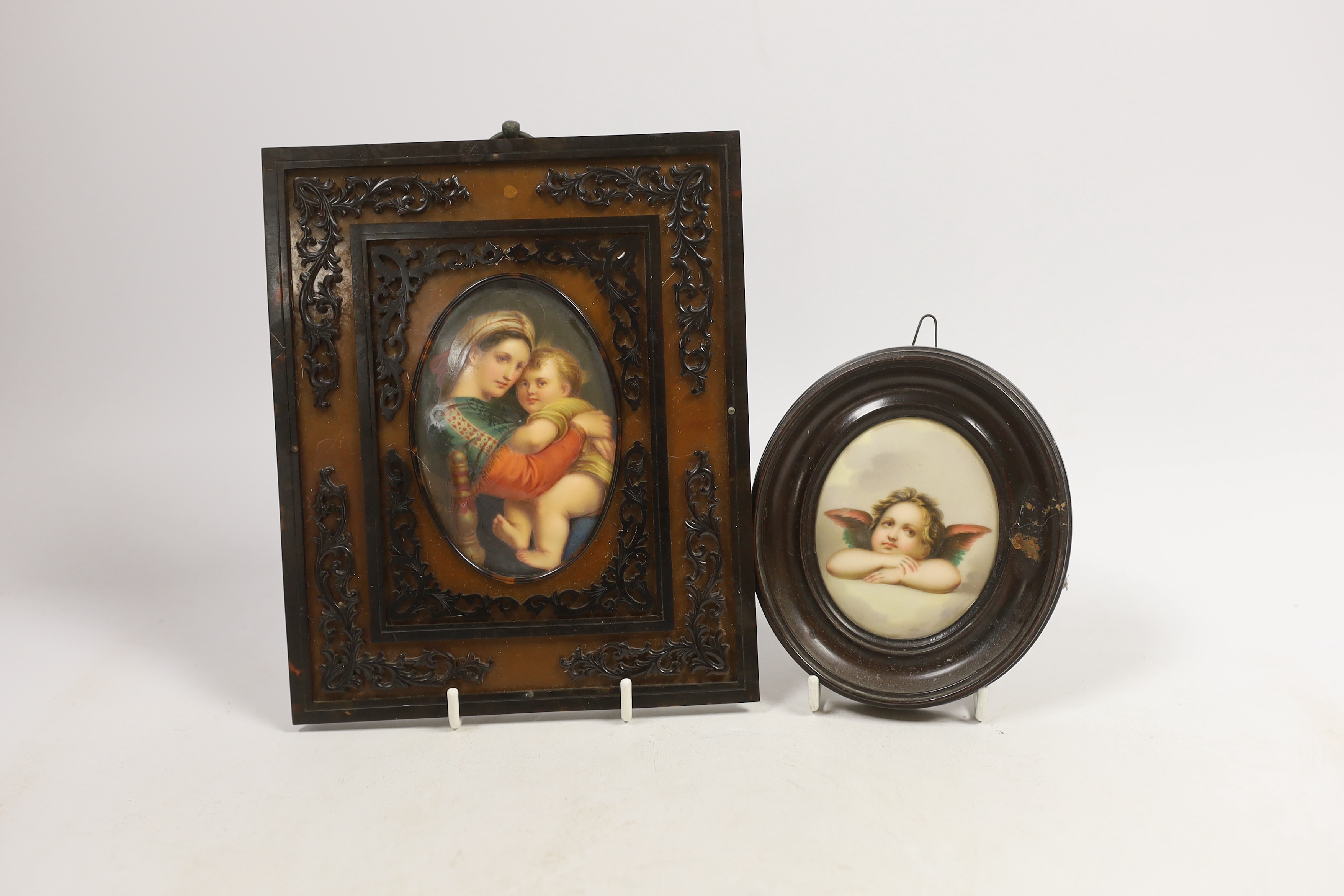 An oval porcelain plaque of mother and child in an ornate frame and a smaller circular porcelain plaque of a putti, mother and child plaque 10.5cm high